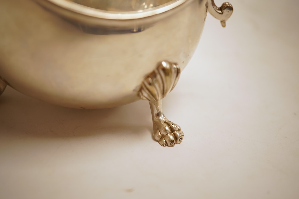 A pair of George V silver sauceboats, with cut borders and flying scroll handles, on three hoof feet, by J.B. Chatterley & Co Ltd, Birmingham, 1928, length 19.3cm, 19.3oz, together with a pair of silver plated Elkington